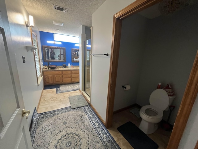 8130 Julie Cv, Millington, TN 38053 - full bath featuring toilet, a shower stall, vanity, a textured ceiling, and baseboards