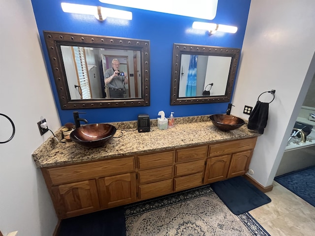 8130 Julie Cv, Millington, TN 38053 - bathroom featuring double vanity and baseboards