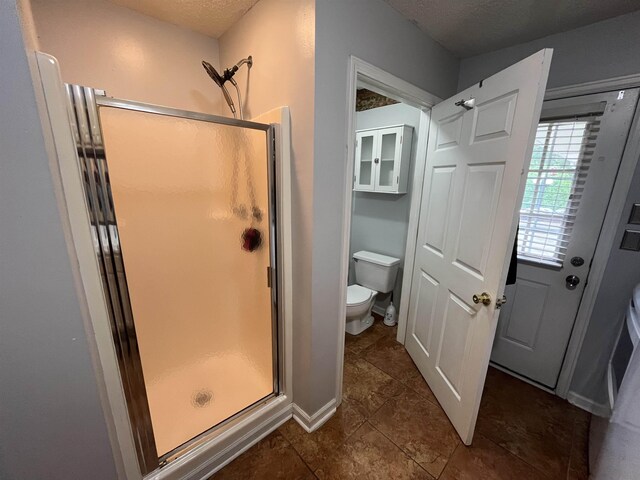 8130 Julie Cv, Millington, TN 38053 - full bathroom featuring toilet, a stall shower, tile patterned floors, and a textured ceiling