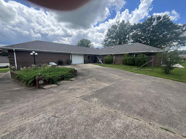 8130 Julie Cv, Millington, TN 38053 - ranch-style home featuring brick siding, an attached garage, concrete driveway, and a front yard