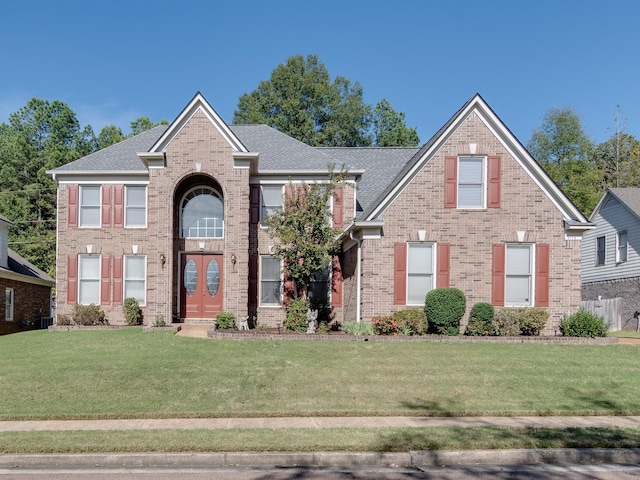 view of front of property with brick siding and a front yard