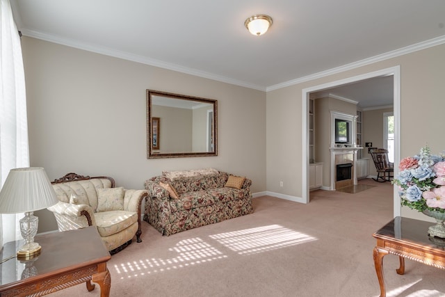 living area with crown molding, carpet floors, and baseboards