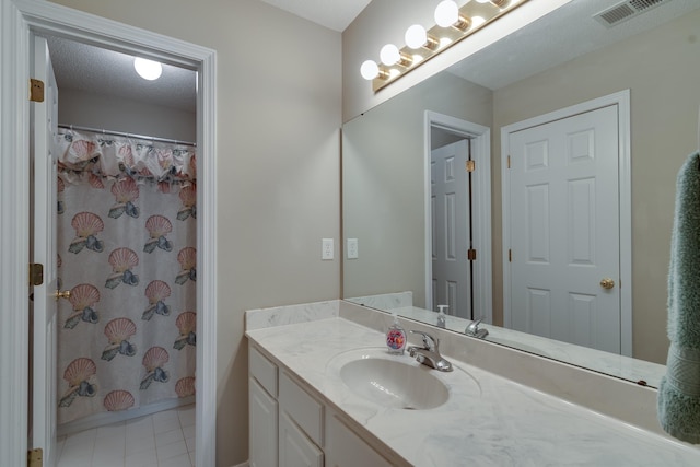 full bath with vanity, tile patterned floors, and curtained shower
