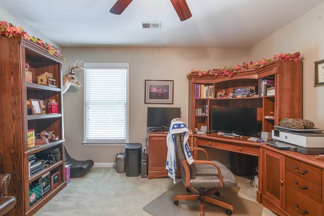 carpeted office with ceiling fan, a textured ceiling, and baseboards