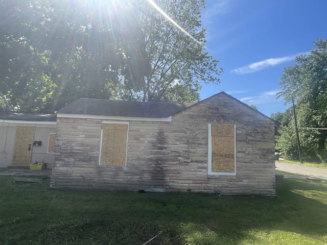 3766 Orchi Rd, Memphis, TN 38108 - view of property exterior featuring stone siding and a yard