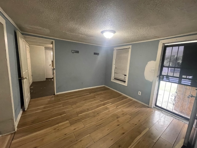 3766 Orchi Rd, Memphis, TN 38108 - spare room with hardwood / wood-style flooring, a textured ceiling, crown molding, and baseboards