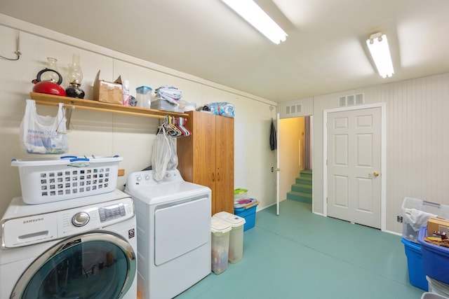 clothes washing area featuring separate washer and dryer