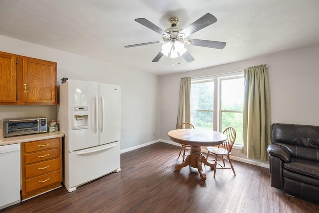 dining area with dark wood-style floors, baseboards, and ceiling fan