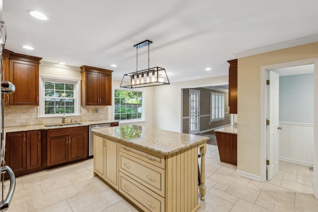kitchen with a sink, dishwasher, ornamental molding, light stone counters, and tasteful backsplash
