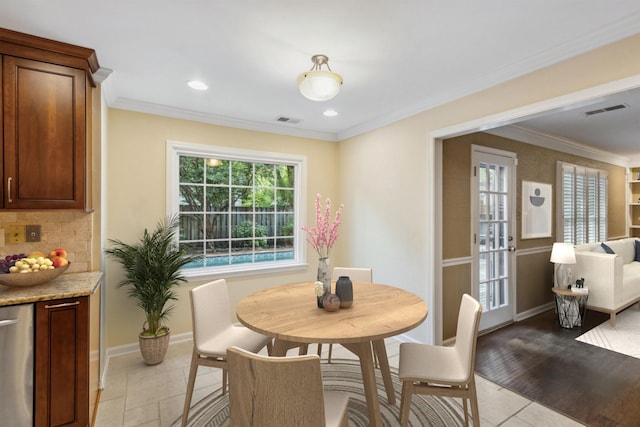 dining space featuring plenty of natural light, ornamental molding, baseboards, light tile patterned floors, and recessed lighting