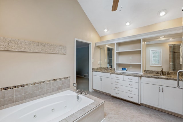 full bathroom featuring lofted ceiling, double vanity, tile patterned flooring, a jetted tub, and a stall shower