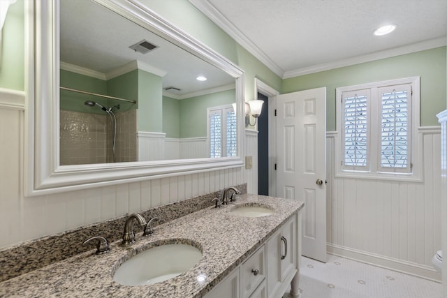 full bathroom with wainscoting, double vanity, crown molding, and recessed lighting