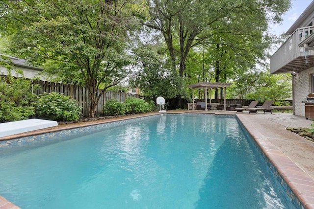 view of swimming pool featuring a fenced backyard and a patio area