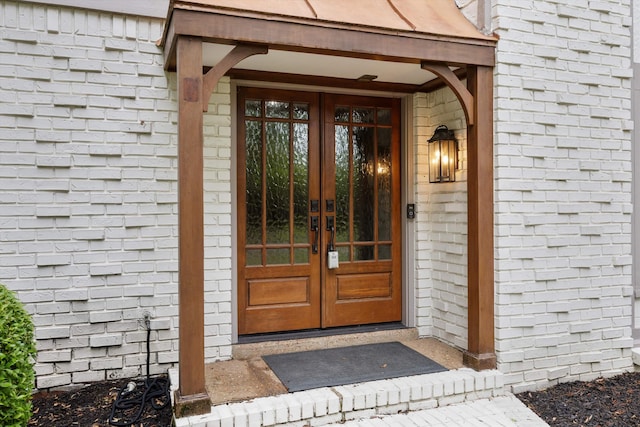 doorway to property with french doors and brick siding