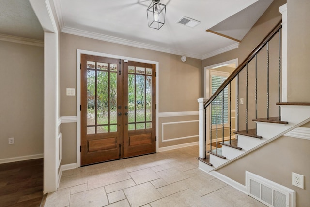 foyer with french doors, stairway, ornamental molding, and baseboards
