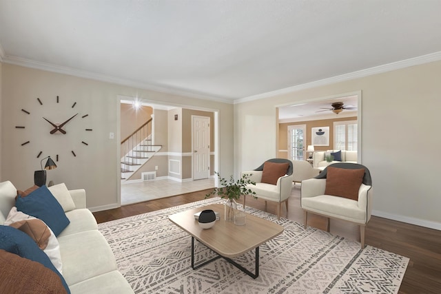 living area with stairway, crown molding, wood finished floors, baseboards, and a ceiling fan