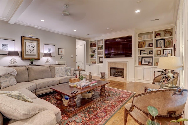 1948 Clarington Dr, Germantown, TN 38138 - living area featuring wood finished floors, a fireplace with flush hearth, ornamental molding, ceiling fan, and built in shelves