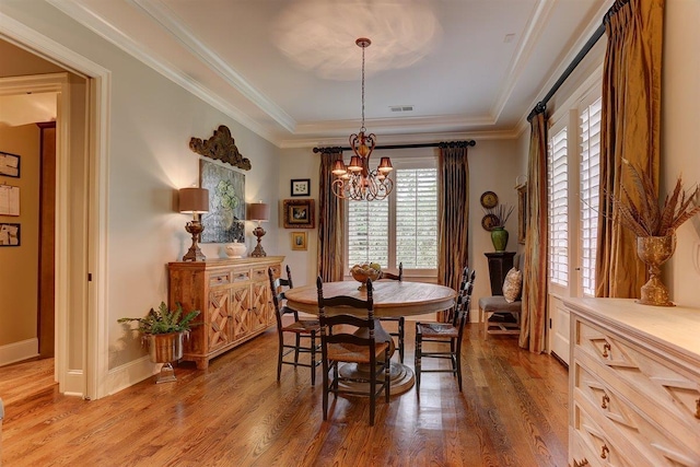 1948 Clarington Dr, Germantown, TN 38138 - dining area with a chandelier, a raised ceiling, wood finished floors, and ornamental molding