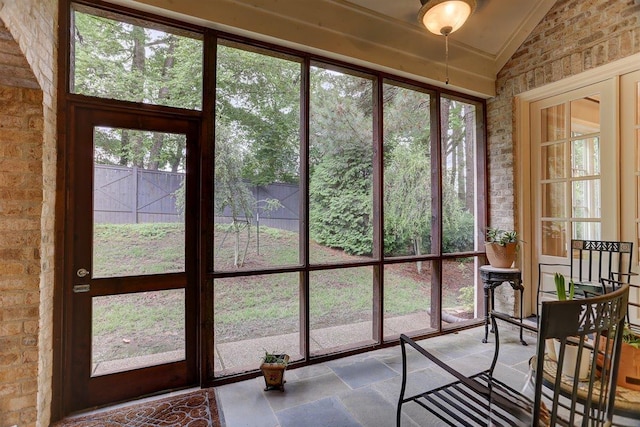 1948 Clarington Dr, Germantown, TN 38138 - sunroom / solarium featuring stone tile floors, vaulted ceiling, and brick wall