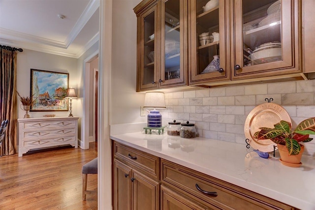 1948 Clarington Dr, Germantown, TN 38138 - bar featuring ornamental molding, tasteful backsplash, and light wood-style flooring