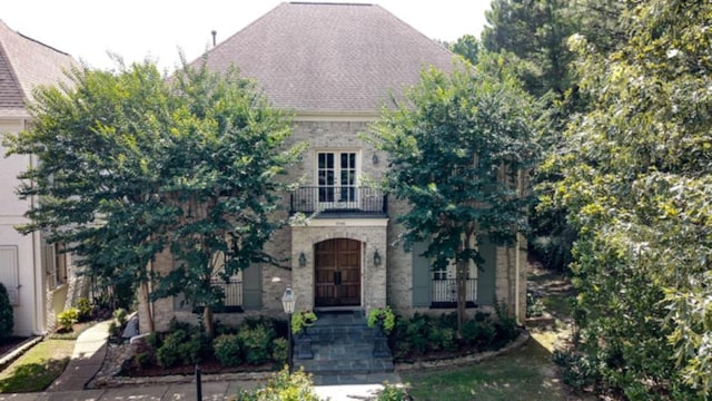 1948 Clarington Dr, Germantown, TN 38138 - view of front of property featuring a balcony, brick siding, and roof with shingles