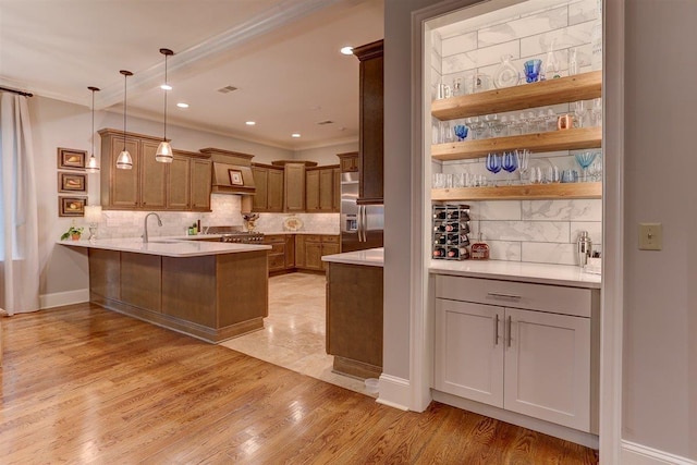 1948 Clarington Dr, Germantown, TN 38138 - kitchen with stainless steel refrigerator with ice dispenser, crown molding, a peninsula, decorative backsplash, and light countertops