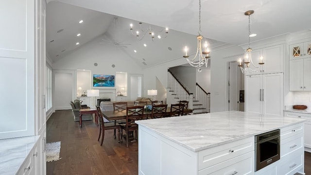 335 Blain St, Rossville, TN 38066 - kitchen featuring high vaulted ceiling, open floor plan, dark wood-style floors, a chandelier, and a center island