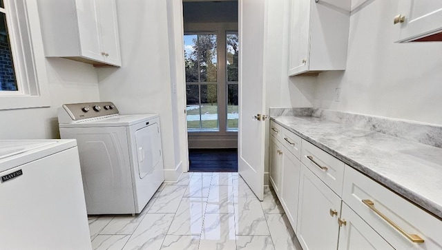 335 Blain St, Rossville, TN 38066 - laundry area featuring washing machine and dryer, cabinet space, and light marble finish floors