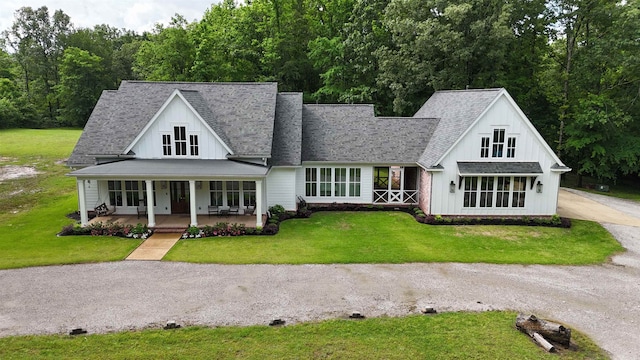 335 Blain St, Rossville, TN 38066 - modern inspired farmhouse featuring covered porch, a front lawn, driveway, and a shingled roof