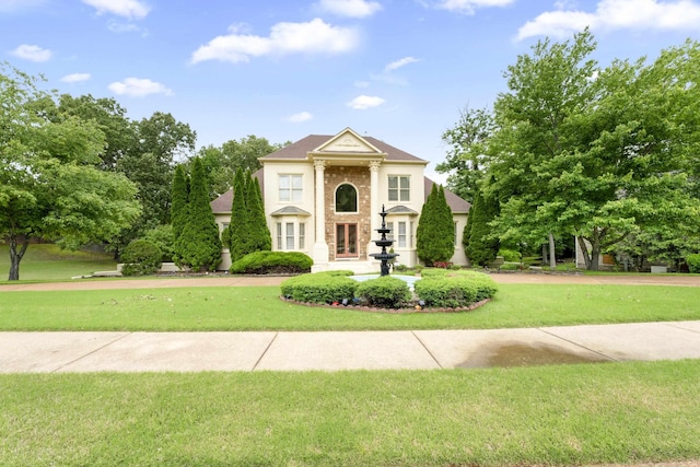 greek revival house featuring a front lawn