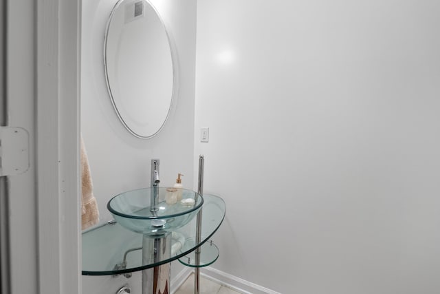 bathroom with baseboards and tile patterned floors