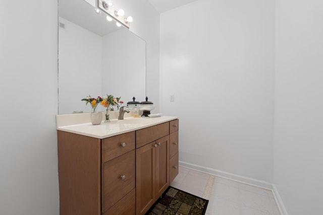 bathroom with vanity, baseboards, and tile patterned floors