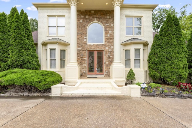 view of front facade featuring french doors and brick siding