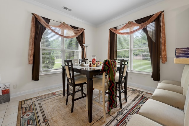 dining area with baseboards, light tile patterned floors, healthy amount of natural light, and ornamental molding