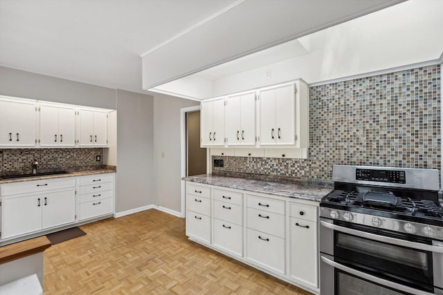 5305 Brantford Ave, Memphis, TN 38120 - kitchen featuring range with two ovens, tasteful backsplash, white cabinets, and baseboards