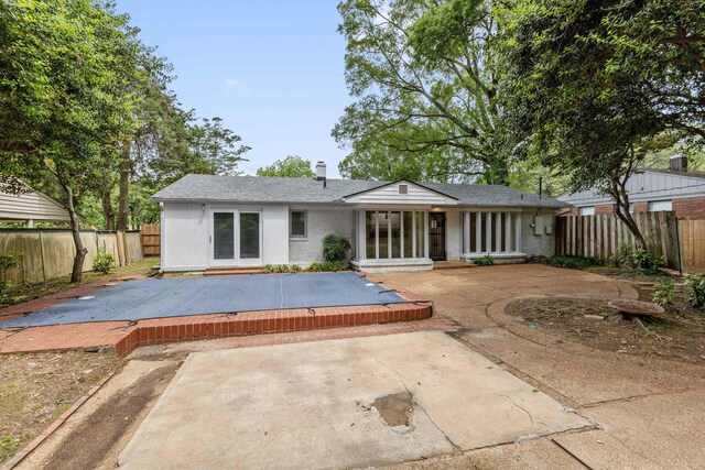 5305 Brantford Ave, Memphis, TN 38120 - rear view of property featuring a patio, a fenced backyard, roof with shingles, and brick siding