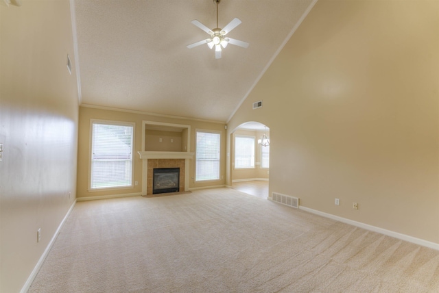 unfurnished living room featuring baseboards, carpet, high vaulted ceiling, and crown molding
