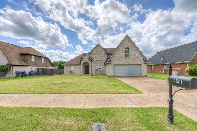 traditional home with driveway, an attached garage, and brick siding