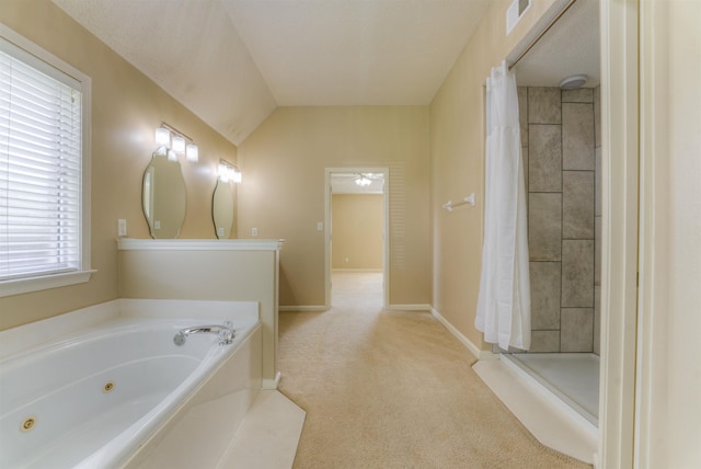 full bath featuring a jetted tub, tiled shower, baseboards, and lofted ceiling