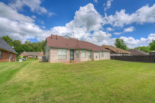 back of property with brick siding and roof with shingles