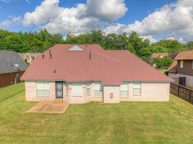 rear view of house featuring brick siding and a patio