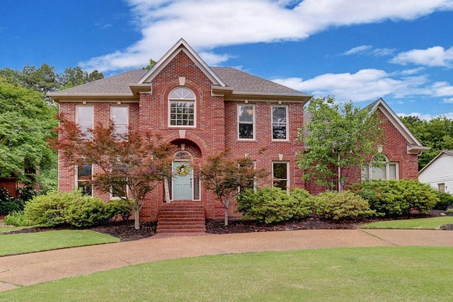 1917 Steeplebrook Cv, Cordova, TN 38016 - view of front of property with a front lawn, brick siding, and roof with shingles