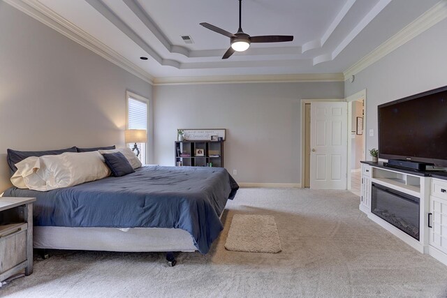 1917 Steeplebrook Cv, Cordova, TN 38016 - carpeted bedroom featuring a raised ceiling, ornamental molding, ceiling fan, and a glass covered fireplace