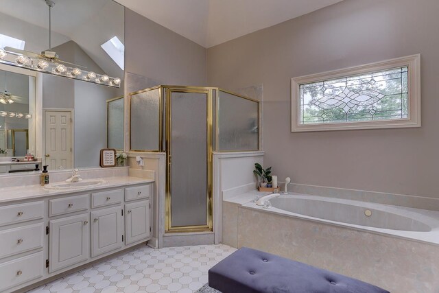 1917 Steeplebrook Cv, Cordova, TN 38016 - full bathroom with vanity, a stall shower, a garden tub, ceiling fan, and vaulted ceiling