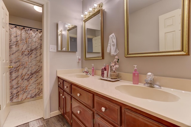 1917 Steeplebrook Cv, Cordova, TN 38016 - bathroom featuring double vanity, baseboards, and a shower with shower curtain