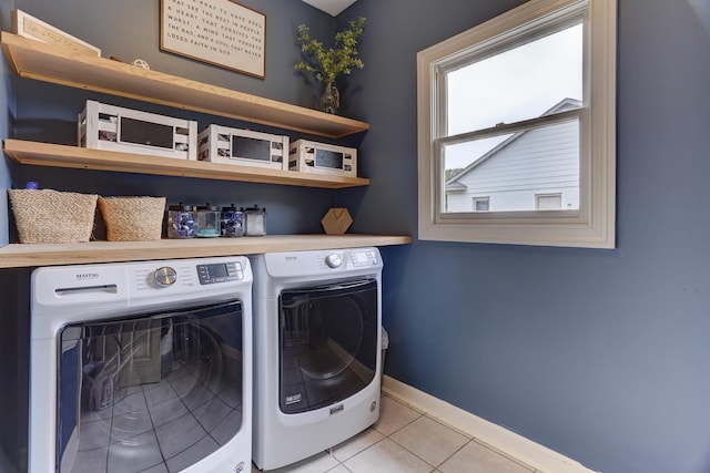1917 Steeplebrook Cv, Cordova, TN 38016 - laundry room featuring separate washer and dryer, light tile patterned floors, and baseboards