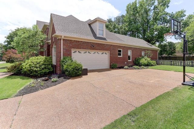 1917 Steeplebrook Cv, Cordova, TN 38016 - view of home's exterior featuring brick siding, driveway, an attached garage, and roof with shingles