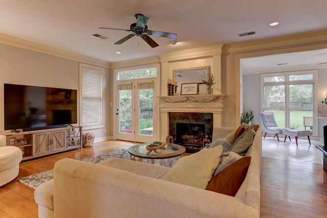 1917 Steeplebrook Cv, Cordova, TN 38016 - living room with crown molding, a premium fireplace, plenty of natural light, a ceiling fan, and wood finished floors