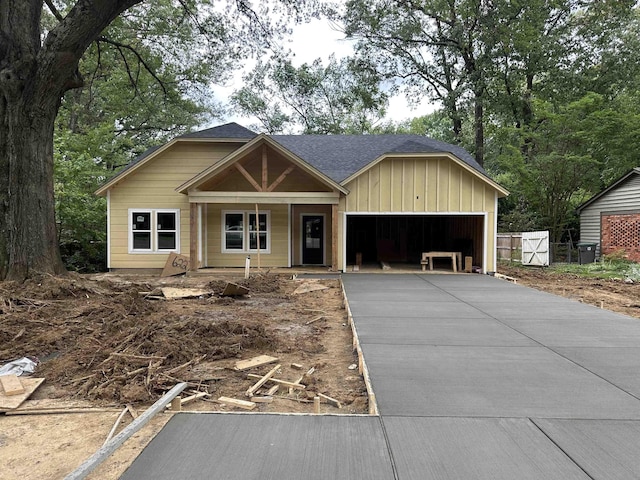 6227 Quince Rd, Memphis, TN 38119 - view of front facade with asphalt driveway, an attached garage, a porch, and board and batten siding