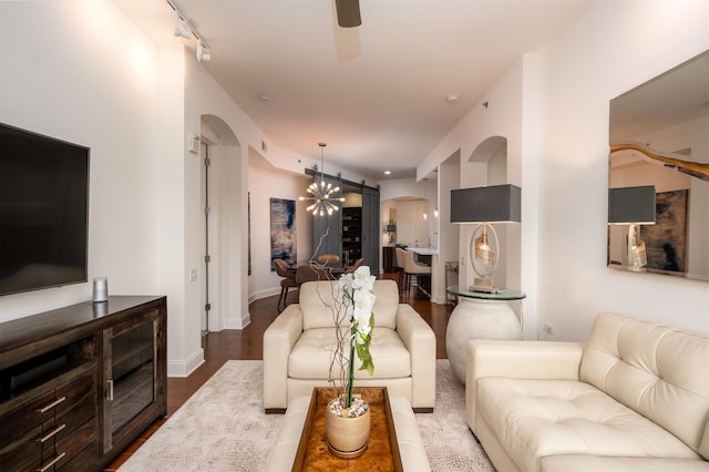 717 S Riverside Dr Unit 1203, Memphis, TN 38103 - living room featuring arched walkways, a ceiling fan, dark wood finished floors, and baseboards